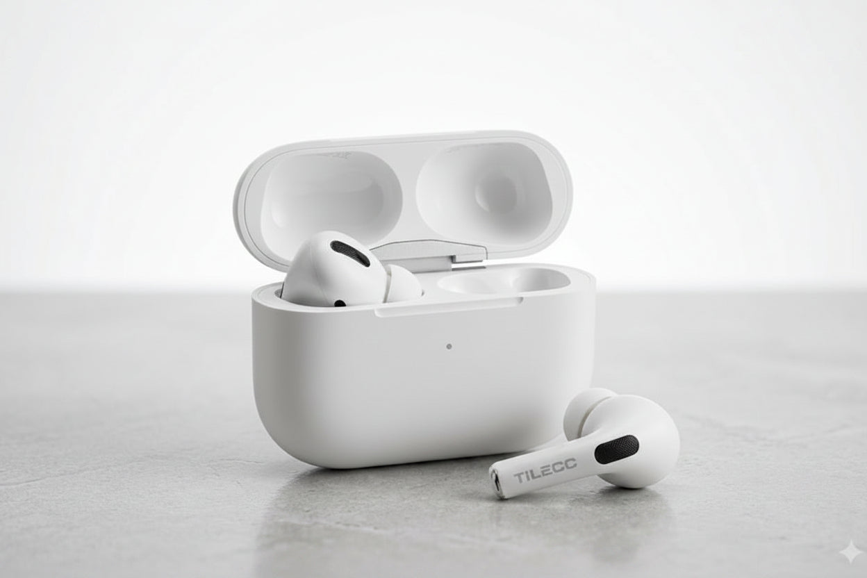 White wireless earbuds with charging case on a light gray surface